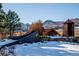 Community entrance with a rustic design and mountain backdrop at 7912 Galileo Way, Littleton, CO 80125