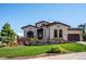 Elegant two-story home with stucco and stone accents, beautifully landscaped grounds at 7912 Galileo Way, Littleton, CO 80125