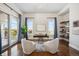Peaceful home office with hardwood floors, built-in shelves, and access to a balcony at 7912 Galileo Way, Littleton, CO 80125