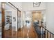 Bright and spacious hallway with a barn door, hardwood floors and a brick fireplace at 7912 Galileo Way, Littleton, CO 80125