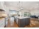Open kitchen design with large island, stainless appliances, and views to living area at 7912 Galileo Way, Littleton, CO 80125
