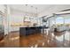 Open concept kitchen with island, stainless steel appliances, and white cabinets at 7912 Galileo Way, Littleton, CO 80125