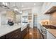 Gourmet kitchen with farmhouse sink, custom cabinetry, and breakfast bar at 7912 Galileo Way, Littleton, CO 80125