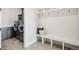 Convenient laundry room with built-in cabinetry and a bench at 7912 Galileo Way, Littleton, CO 80125