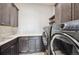 Well-appointed laundry room with washer, dryer, and ample counter space at 7912 Galileo Way, Littleton, CO 80125
