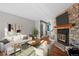 Bright living room features a stone fireplace and hardwood floors at 1245 S Idalia St, Aurora, CO 80017