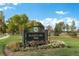 Sloan's Lake Park sign with lush landscaping and paved walkway at 4215 W Byron Pl, Denver, CO 80212