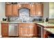 Basement bar with granite countertops, wood cabinets, and stainless steel appliances at 6937 Brookeview Ct, Parker, CO 80134