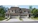 Two-story townhome with attached garage and attractive landscaping at 6699 Juniper Dr, Thornton, CO 80602