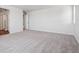 Spacious bedroom with carpet and door to bathroom at 3302 N Highlands Creek Pkwy, Aurora, CO 80019