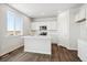 Modern kitchen with white cabinets, island, and stainless steel appliances at 3302 N Highlands Creek Pkwy, Aurora, CO 80019