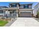 Two-story home with front porch and attached garage at 3302 N Highlands Creek Pkwy, Aurora, CO 80019