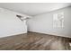 Bright living room with wood-look floors and large window at 3302 N Highlands Creek Pkwy, Aurora, CO 80019