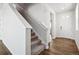 Staircase with gray carpet and hardwood flooring at 3302 N Highlands Creek Pkwy, Aurora, CO 80019