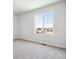 Cozy bedroom with a large window and neutral carpeting at 3302 N Highlands Creek Pkwy, Aurora, CO 80019