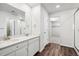 Bathroom with double vanity, walk-in shower, and large closet at 3302 N Highlands Creek Pkwy, Aurora, CO 80019