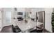 Modern kitchen with white cabinets and granite island at 237 S Old Hammer St, Aurora, CO 80018
