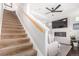 Beige carpeted stairs with wooden railing at 237 S Old Hammer St, Aurora, CO 80018