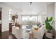 Open living room with white couch, city view, and kitchen at 2001 Lincoln St # 722, Denver, CO 80202