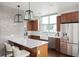 Modern kitchen with breakfast bar and subway tile backsplash at 2001 Lincoln St # 722, Denver, CO 80202