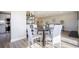 Bright dining area with round table and four white chairs at 4570 E Yale Ave # 301, Denver, CO 80222