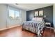 Cozy bedroom with a bed, nightstand, and accent wall at 10785 W 63Rd Pl # 307, Arvada, CO 80004