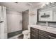 Modern bathroom with a walk-in shower, dark vanity, and mosaic tile at 10785 W 63Rd Pl # 307, Arvada, CO 80004