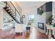 Bright living room with hardwood floors, fireplace, and modern furnishings at 10785 W 63Rd Pl # 307, Arvada, CO 80004