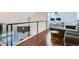 Loft overlooking living room with desk area and modern railing at 10785 W 63Rd Pl # 307, Arvada, CO 80004