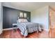 Simple bedroom with a bed and hardwood floors at 10785 W 63Rd Pl # 307, Arvada, CO 80004