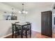Bright dining area with a table and chairs, a mirrored wall, and dark wood storage at 10785 W 63Rd Pl # 307, Arvada, CO 80004