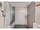 Large walk-in shower with gray tile and a built-in seat at 10785 W 63Rd Pl # 307, Arvada, CO 80004