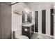 Clean bathroom with a vanity, toilet, and black and white striped walls at 10785 W 63Rd Pl # 307, Arvada, CO 80004