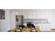 Modern kitchen with stainless steel appliances and white cabinets at 12983 W Ida Ave # 109 Ada Type A, Littleton, CO 80127