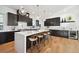 Contemporary kitchen featuring dark cabinetry and a large island at 2650 Zenobia, Denver, CO 80212