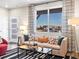 Living room with comfortable sofa and large window at 13923 Vispo Way, Broomfield, CO 80020