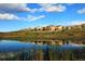 Lakefront community view with reflection of homes and clouds at 4693 Twelve Oaks Way, Castle Rock, CO 80104