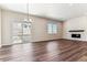 Bright dining room features hardwood floors, a fireplace, and sliding glass doors to a deck at 4693 Twelve Oaks Way, Castle Rock, CO 80104