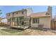 Backyard view showcasing a sunroom addition and a spacious yard at 10021 Miller St, Broomfield, CO 80021