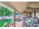 Relaxing covered porch with a swing overlooking the front yard at 10021 Miller St, Broomfield, CO 80021