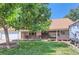 Ranch-style home with covered porch, mature trees, and RV parking at 10021 Miller St, Broomfield, CO 80021