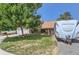 House exterior with a spacious yard, trees, and an RV parked in the driveway at 10021 Miller St, Broomfield, CO 80021