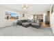 Spacious living room with gray sectional sofa and large window at 2125 E 150Th Pl, Thornton, CO 80602