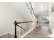 Modern staircase with dark wood railing and light gray flooring at 2125 E 150Th Pl, Thornton, CO 80602