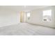 Bright and airy bedroom with grey carpet and large windows at 1594 Farmstead St, Brighton, CO 80601