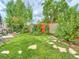 Landscaped backyard with a stone pathway and green grass at 17045 Hastings Ave, Parker, CO 80134