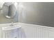Small bathroom with white pedestal sink and gray walls at 11615 Masonville Dr, Parker, CO 80134