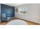 Spacious bedroom with hardwood floors and a blue accent wall at 11615 Masonville Dr, Parker, CO 80134