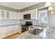 Updated kitchen with granite countertops and white cabinets at 11615 Masonville Dr, Parker, CO 80134