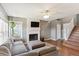 Living room with sectional sofa and fireplace, access to stairs at 11615 Masonville Dr, Parker, CO 80134